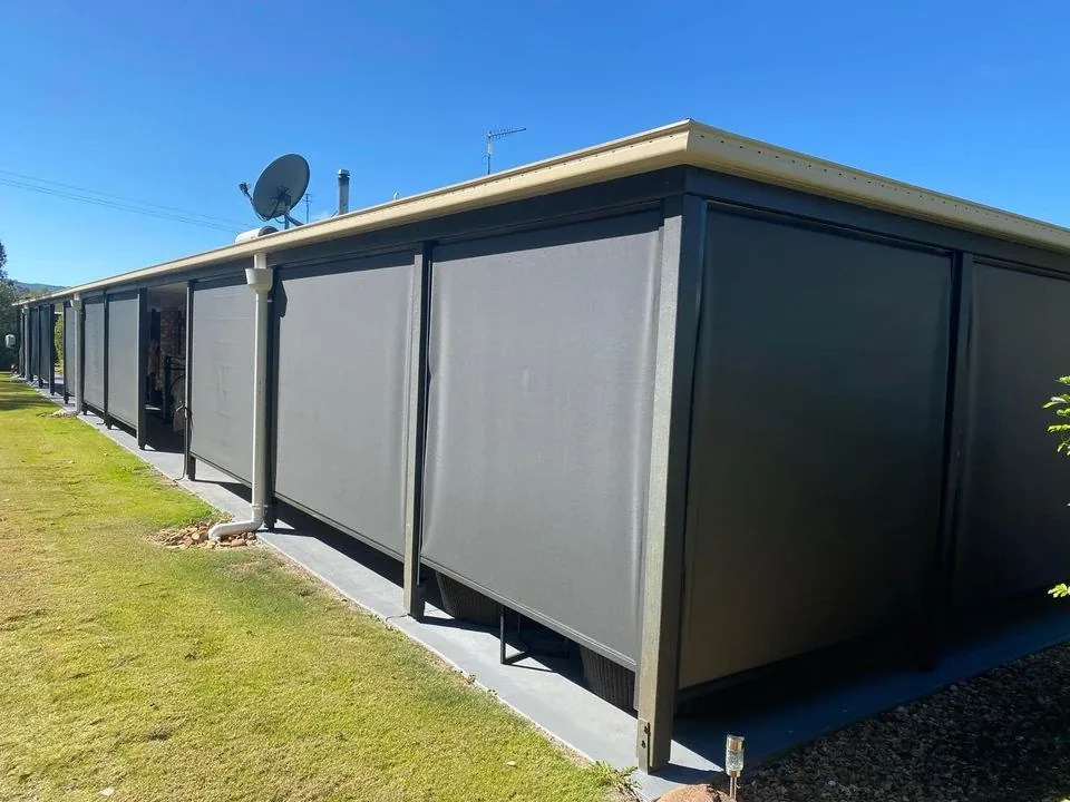 Zipscreen blinds lowered along an outdoor entertaining area under a patio roof