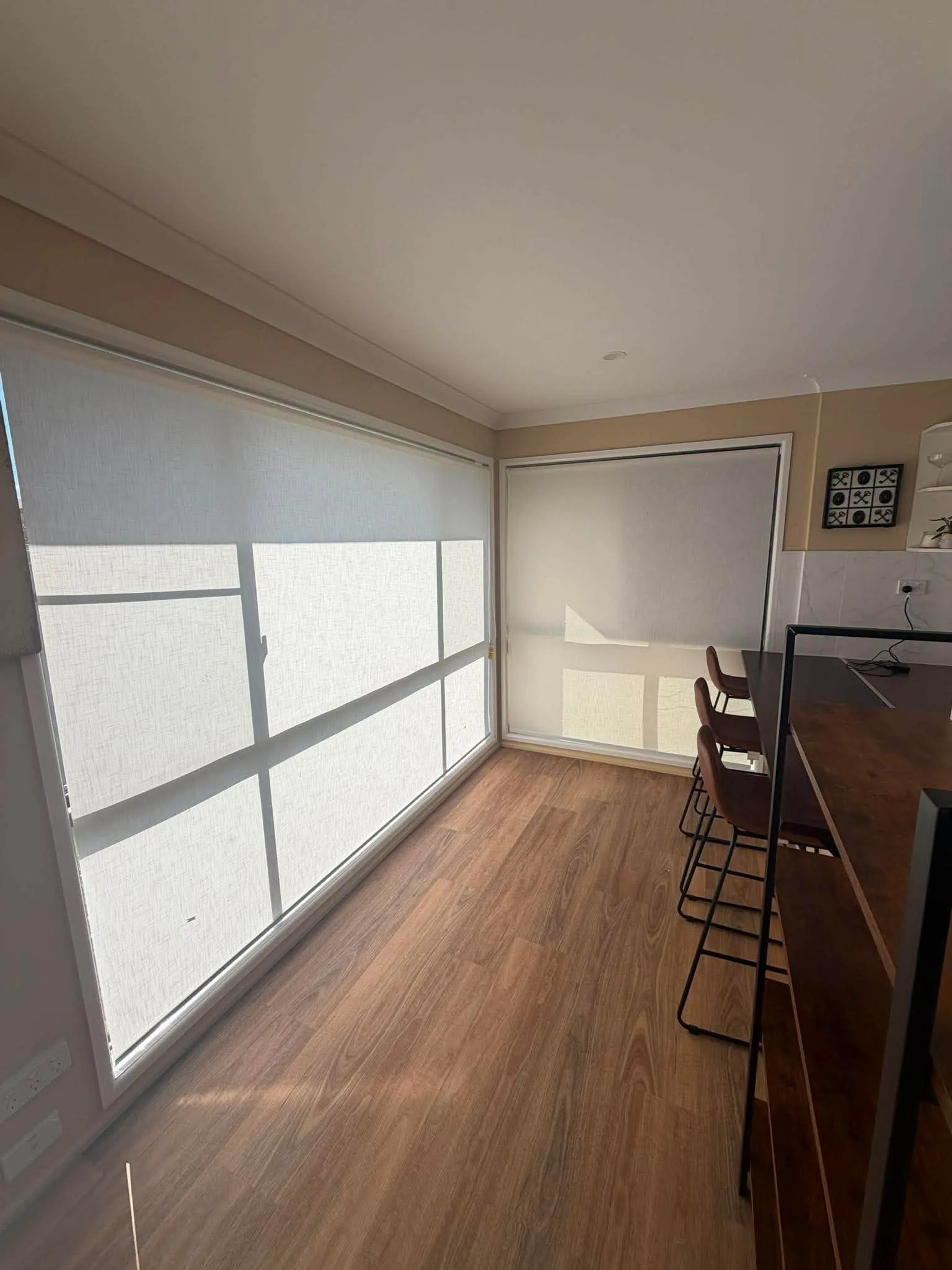 Roller blinds fitted across corner windows in a Toowoomba living room
